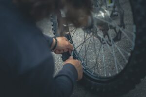 person working on bike tire repair