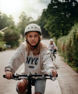 girl biking wearing helmet