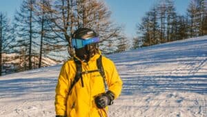 person wearing ski jacket, goggles, and helmet