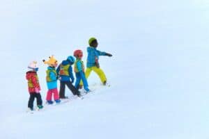 kids skiing in a line