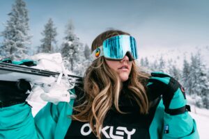 woman holding skis behind her head